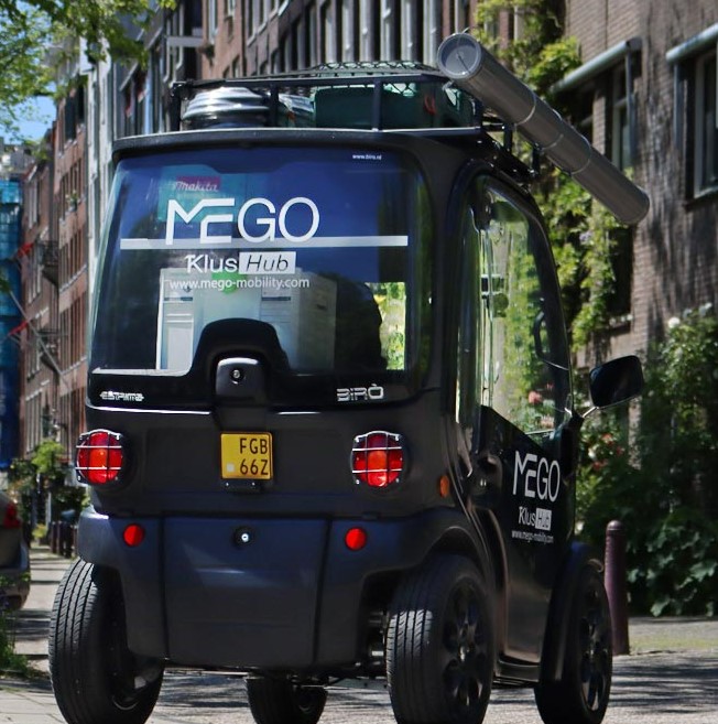 electric vehicle with special carriers to carry DIY materials for craftsmen driving in Amsterdam