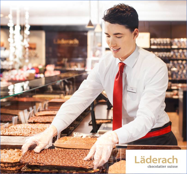 smiling sales staff presenting chocolate