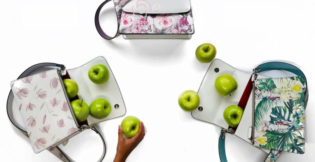 Showing 3 handbags with different designs made from apples